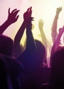 Hands, dancing and fans at concert or music festival from back, neon light and energy at live event. Dance, fun and Royalty Free Stock Photo