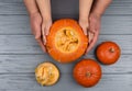 Hands of a daughter and father who pulls seeds and fibrous material from a pumpkin before carving for Halloween. Party Royalty Free Stock Photo