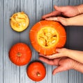 Hands of a daughter and father who pulls seeds and fibrous material from a pumpkin before carving for Halloween. Party Royalty Free Stock Photo