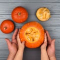 Hands of a daughter and father who pulls seeds and fibrous material from a pumpkin before carving for Halloween. Party Royalty Free Stock Photo