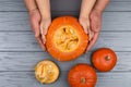 Hands of a daughter and father who pulls seeds and fibrous material from a pumpkin before carving for Halloween. Party Royalty Free Stock Photo