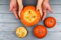 Hands of a daughter and father who pulls seeds and fibrous material from a pumpkin before carving for Halloween. Party Royalty Free Stock Photo