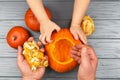 Hands of a daughter and father who pulls seeds and fibrous material from a pumpkin before carving for Halloween. Party Royalty Free Stock Photo