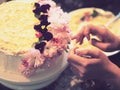 Hands decorating a cake with flowers Royalty Free Stock Photo