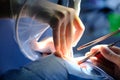 The hands of the dentist and the assistant in protective gloves