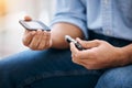 Hands, diabetes and measurement with a man in his home holding a blood glucose meter for disability awareness Royalty Free Stock Photo