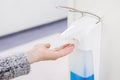 Hands disinfection dispenser in medical center. Antibacterial procedure. Health care and sanitary