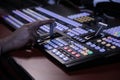 Hands on dissolve of Switcher buttons in studio TV station Audio and Video Production Switcher