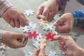 Hands of diverse people assembling jigsaw puzzle, help support Royalty Free Stock Photo