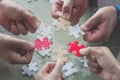 Hands of diverse people assembling jigsaw puzzle, help support Royalty Free Stock Photo