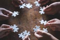 Hands of diverse people assembling jigsaw puzzle, Youth team put Royalty Free Stock Photo