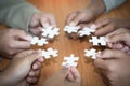 Hands of diverse people assembling jigsaw puzzle, Youth team put pieces together searching for right match, help support in Royalty Free Stock Photo