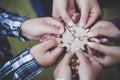 Hands of diverse people assembling jigsaw puzzle, Youth team put pieces together searching for right match, help support in Royalty Free Stock Photo