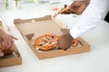 Hands of diverse people taking pizza slices, close up view