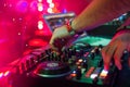 Hands DJ mixing and playing music on a professional controller mixer Royalty Free Stock Photo