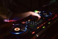 DJ desk in a nightclub party with hands. Studio DJ equipment glowing with light Royalty Free Stock Photo