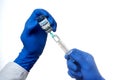 Infectious disease physician draws coronavirus vaccine from bottle into syringe