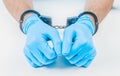 Hands of a doctor in handcuffs. The concept of corruption in medicine