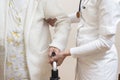 Hands of a doctor helping and belaying an old woman and an old woman`s hand holding a rehabilitation walker.