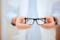 Hands of a Doctor Holding Prescription Eyeglasses Royalty Free Stock Photo
