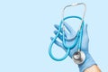 Hands of the doctor holds a stethoscope. This is a medical tool for listening to the heart rhytm and