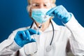 Hands of a doctor in medical gloves draws a liquid vaccine against the corona virus covid 19 into a syringe from a vial preparing Royalty Free Stock Photo