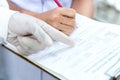 Hands Doctor and nurse holding clipboard for checking report of patient.