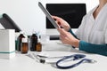 Hands doctor using digital tablet close up at desk in office Royalty Free Stock Photo