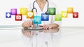 Hands of doctor woman touch digital tablet at office desk with medical symbols icons isolated on white