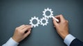 Hands drawing interlocking gears representing teamwork and collaboration Royalty Free Stock Photo