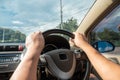 Hands driving a car in home town, safety drive and car insurance concept Royalty Free Stock Photo