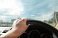 Hands driving a car in home town, safety drive and car insurance concept Royalty Free Stock Photo