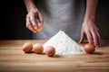 Hands, eggs and flour. Basic dough for fresh egg pasta recipe. Royalty Free Stock Photo