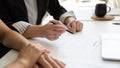 Hands of elderly female client reading and signing contract Royalty Free Stock Photo