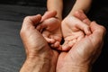 Hands of elderly man holding hand of younger man Royalty Free Stock Photo