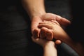 Hands of elderly man holding hand of younger man. Royalty Free Stock Photo