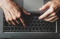 Hands of an elderly man learning to use computer, typing on a laptop, top view Royalty Free Stock Photo