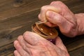 Hands of an elderly man opening a aluminium tin can. Royalty Free Stock Photo