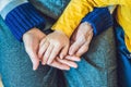 The hands of an elderly person and the hands of a child, the con Royalty Free Stock Photo