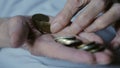 The hands of an elderly woman consider a trifle. The poor pensioner counts the last money. Coins in the hand of an old Royalty Free Stock Photo