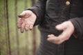 Hands of an elderly woman without gloves, stained soil after working in the garden