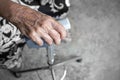 The hands of an elderly woman have curly fingers and wrinkled, holding the old cane sitting alone Royalty Free Stock Photo