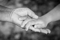 Hands of an elderly woman holding the hand of a younger woman Royalty Free Stock Photo