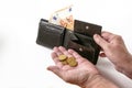 Hands of an elderly woman with a money purse and few euro coins and banknotes, cash check in the economic crisis affected by Royalty Free Stock Photo