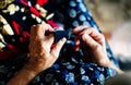 Hands of an elderly woman sewing close up views Royalty Free Stock Photo