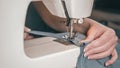 hands of an elderly woman sewing on a sewing machine. Close-up Royalty Free Stock Photo