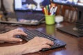 Hands of an elderly woman typing on a pc keyboard Royalty Free Stock Photo