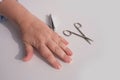 Hands of an elderly woman in wrinkles close-up, clippers, scissors, cutting nails, care, manicure at home, concept of beauty and Royalty Free Stock Photo