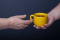 Hands of elderly and young women on black background Royalty Free Stock Photo