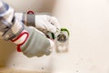 Hands of electrician installing socket in gypsum wall Royalty Free Stock Photo